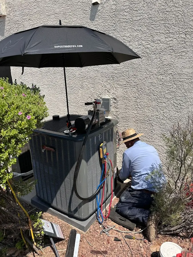 HVAC technician performing outdoor AC maintenance in Albany